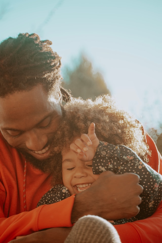 A child and parent laugh