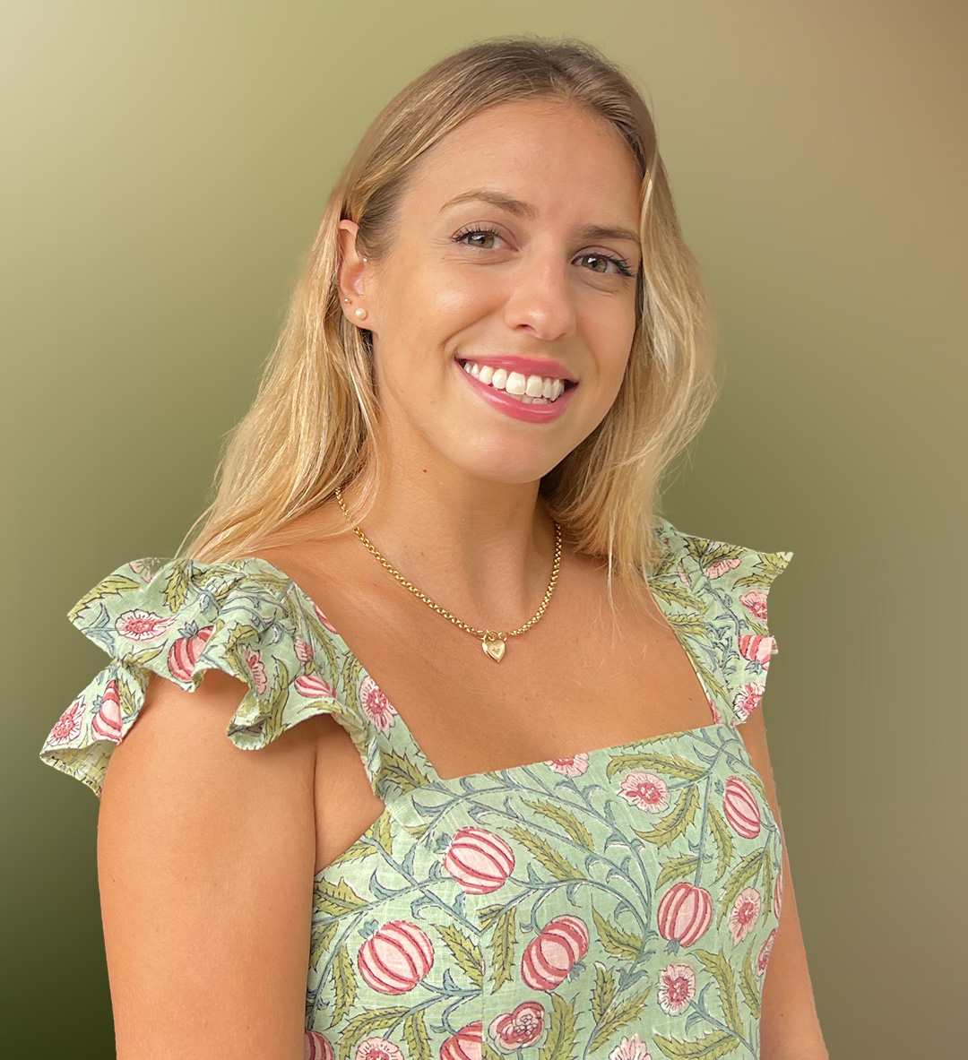 A woman smiles at the camera.