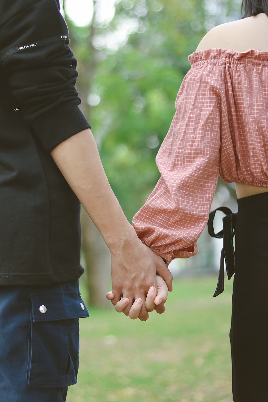 A couple holds hands